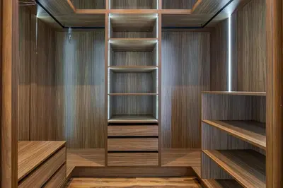 a walk in closet with wooden shelves and wooden floors at Villa de plain-pied avec piscine chauffée à Marrakech in Marrakech