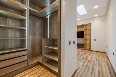 a walk in closet with wooden shelves at Villa de plain-pied avec piscine chauffée à Marrakech in Marrakech