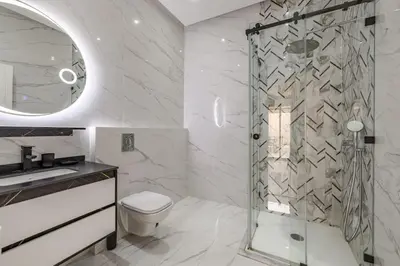 a bathroom with a shower and a toilet and a sink at Villa de plain-pied avec piscine chauffée à Marrakech in Marrakech