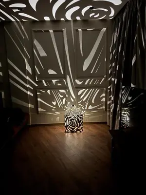 a room with a zebra patterned wall and a lamp at Suite Bahiya 19 in Fès