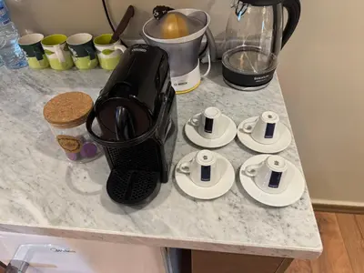 a black blender sitting on a counter with cups at Suite Bahiya 19 in Fès