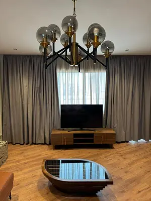 a living room with a television and a table at Suite Bahiya 19 in Fès