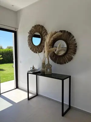 a table with two mirrors on a white wall at Villa soléa - Route Ouarzazate in Marrakech