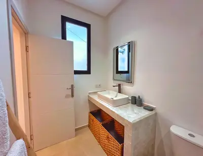 a bathroom with a sink and a mirror at Villa soléa - Route Ouarzazate in Marrakech