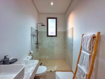 a bathroom with a shower and a toilet and a sink at Villa soléa - Route Ouarzazate in Marrakech