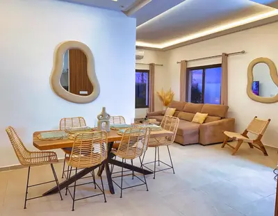 a living room with a table and chairs and a couch at Villa soléa - Route Ouarzazate in Marrakech