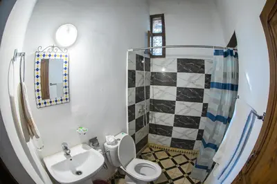 a bathroom with a sink and a toilet and a shower at Dar Fez Arinas - Rooftop View - Central Fez in Fès