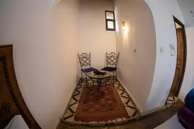 a small table and two chairs in a hallway at Dar Fez Arinas - Rooftop View - Central Fez in Fès