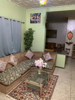 a living room with a couch and a table at Quartier labeta centre ville in Fès