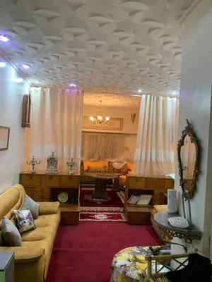 a living room with a couch and a living room with at Quartier labeta centre ville in Fès