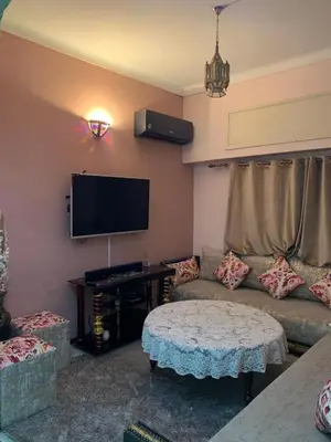 a living room with a couch and a flat screen tv at Quartier labeta centre ville in Fès