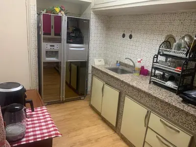 a kitchen with a sink and a refrigerator at Quartier labeta centre ville in Fès