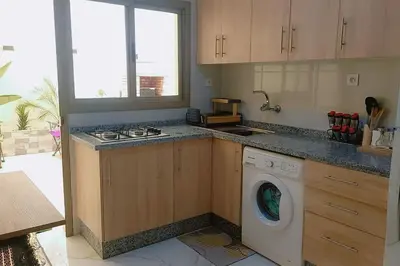 a kitchen with a washing machine in a kitchen at appartement meublé moderne in Fès