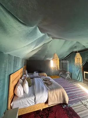 a bedroom with a bed in a tent at Desert Bliss in Merzouga