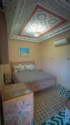 a bedroom with a bed and a coffered ceiling at Riad Golden Mansour in Meknès