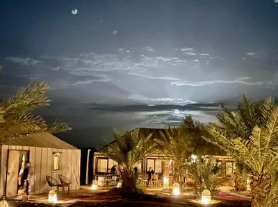 a view of a house at night with a sky at Luxury Merzouga Camp in Merzouga