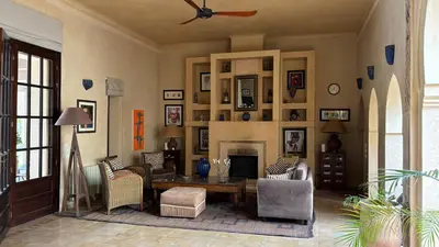 a living room with a table and chairs and a fireplace at Palais Celoa in Marrakech
