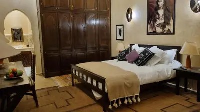 a bedroom with a large bed with pillows on it at Palais Celoa in Marrakech