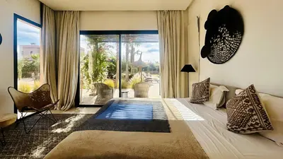a living room with a couch and a large window at Villa Sbaa Marrakech in Marrakech