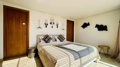 a bedroom with a bed and some pictures on the wall at Villa Sbaa Marrakech in Marrakech
