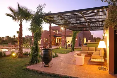 a patio with a couch and a pergola at Villa Sbaa Marrakech in Marrakech