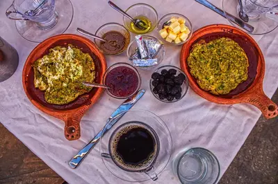 a table with two dishes of food on it at lmtounipalace in Ouarzazate