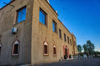 a building with windows on the side of it at lmtounipalace in Ouarzazate