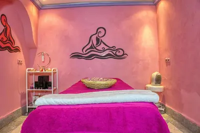 a room with a bed with a mermaid on the wall at lmtounipalace in Ouarzazate