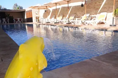 a yellow rubber duck in the middle of a swimming pool at Dar margoum in Marrakech