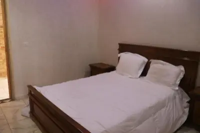 a bedroom with a bed with white sheets and pillows at Dar margoum in Marrakech