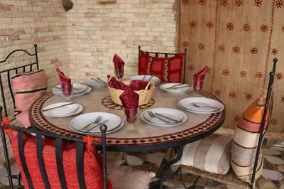 a table with red napkins and plates on it at Dar margoum in Marrakech