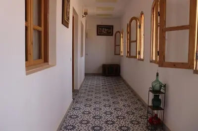 a hallway with a tile floor in a building at Dar margoum in Marrakech