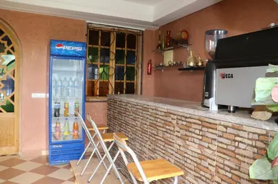 a bar with a soda machine in a restaurant at Dar margoum in Marrakech