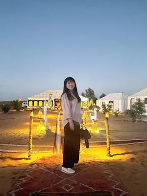 a woman standing in front of a display of lights at Sahara Magic Luxury Camp & Camel trek in Merzouga