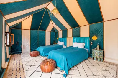 a room with two beds in a tent at Sahara Magic Luxury Camp & Camel trek in Merzouga