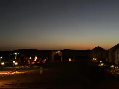 a view of a street at night with lights at Sahara Magic Luxury Camp & Camel trek in Merzouga