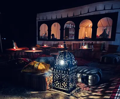 a room with a table with a lamp in it at Sahara Magic Luxury Camp & Camel trek in Merzouga