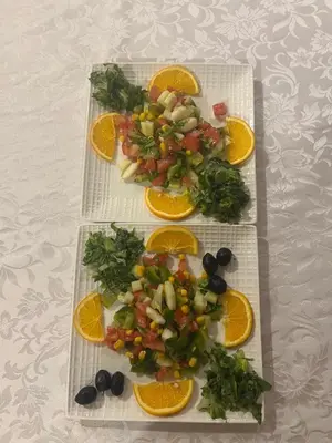 three plates of food with fruit and vegetables on a table at La Sultana Luxury Camp in Merzouga