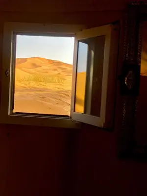 a window in a room with a desert view at Merzouga Luxurious Camp in Merzouga