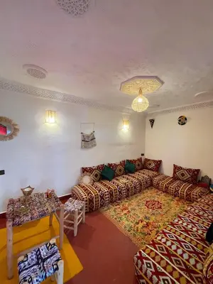 a living room with a couch and a table at Dar Boujloud Fez in Fès