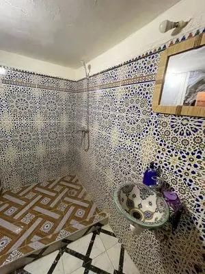 a bathroom with a sink and a mirror at Dar Boujloud Fez in Fès