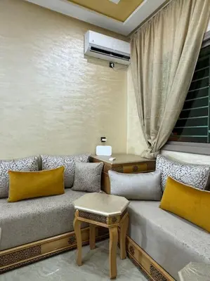 a living room with a couch and a table at Appartement fes centre in Fès