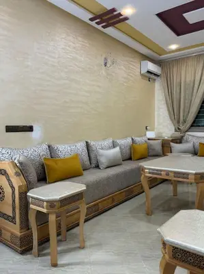 a living room with a couch and two tables at Appartement fes centre in Fès