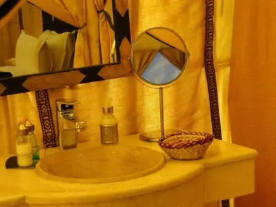 a bathroom sink with a mirror on a counter at White Camp Desert Safari in Merzouga