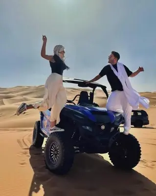 two people on a four wheeler in the desert at White Camp Desert Safari in Merzouga