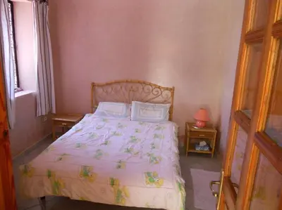 a bedroom with a bed with a white bedspread at John's Place in Marrakech