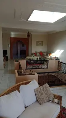 a living room with a white couch and a room with a unintention at John's Place in Marrakech