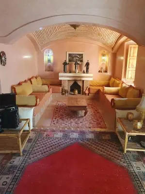 a living room with couches and a fireplace at John's Place in Marrakech