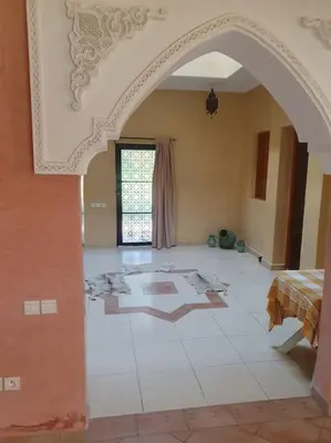a living room with an archway in a house at John's Place in Marrakech