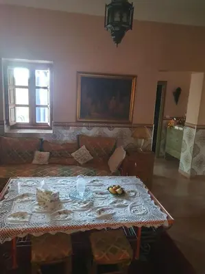 a living room with a table and a couch at John's Place in Marrakech